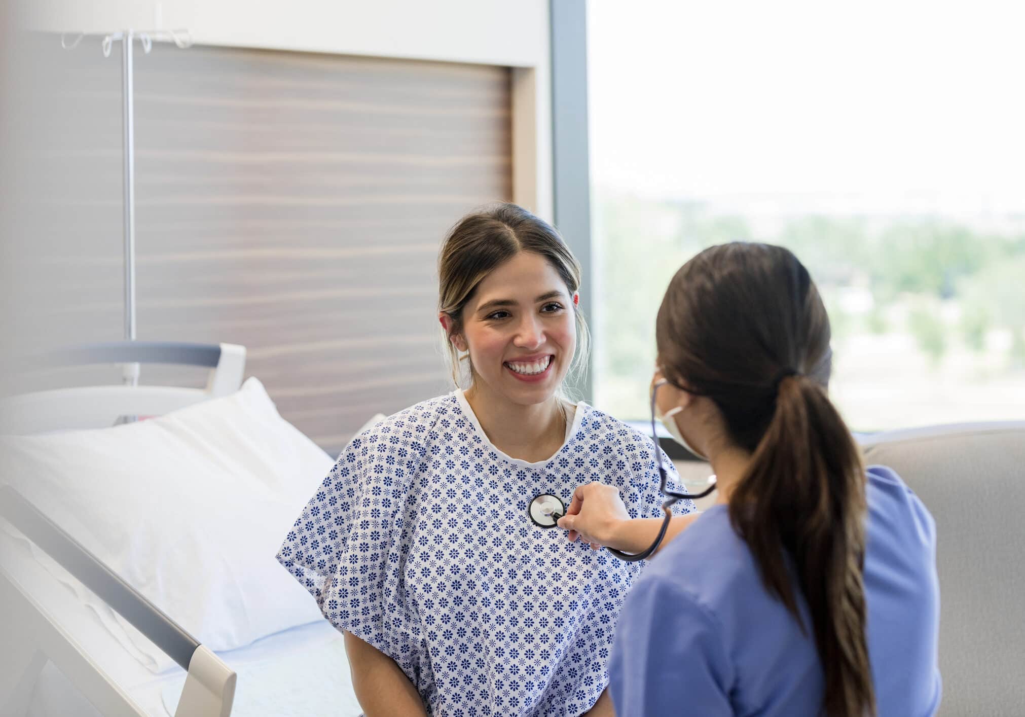 Young adult woman smiles at the cardiologist